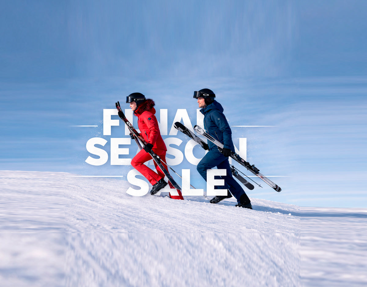 Final Season Sale: rebajas de esquí Tsunami, pareja subiendo con los esquís por la nieve